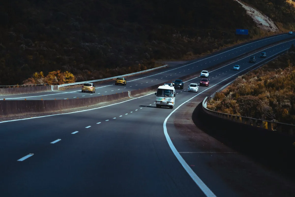 Highway with traffic next to a hillside