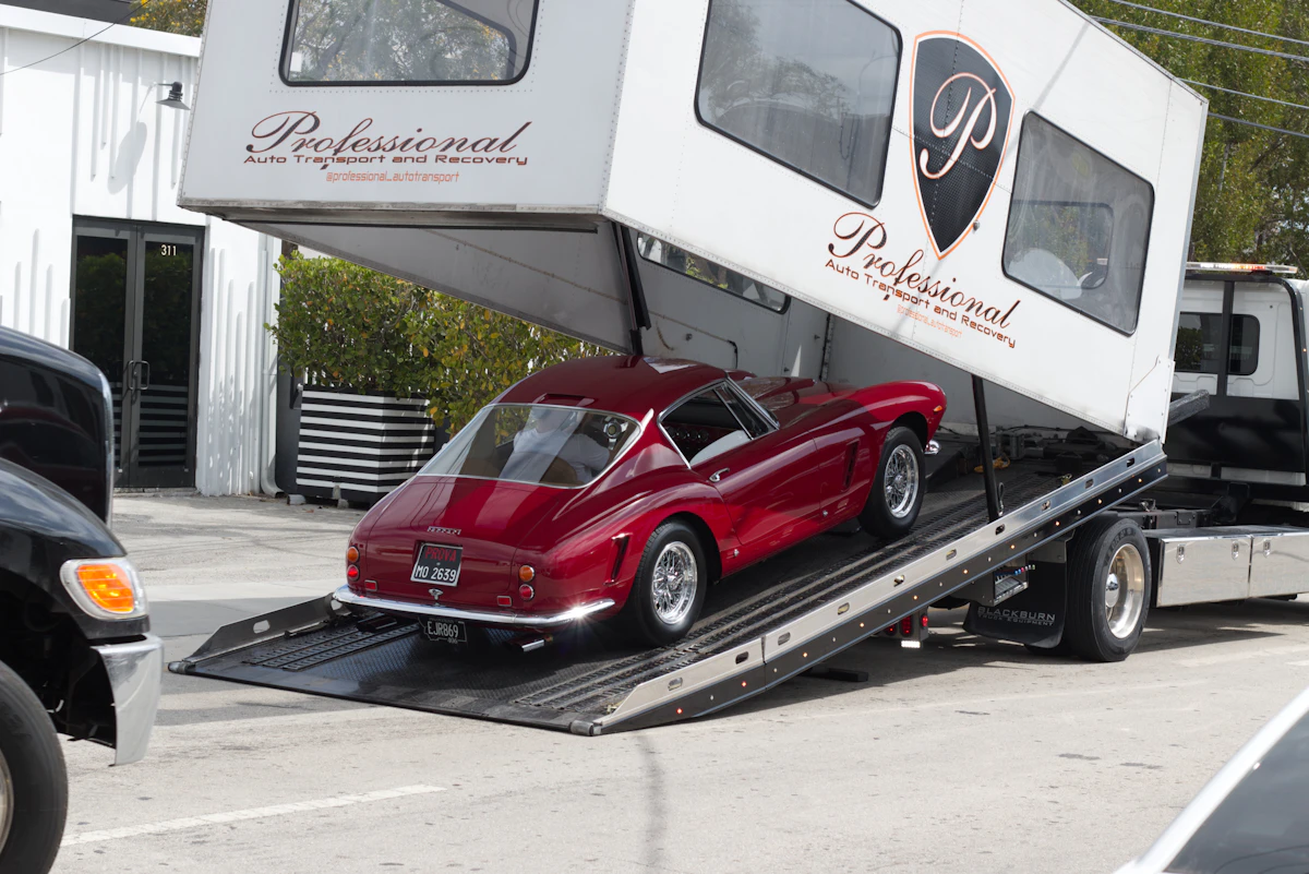 Classic car being loaded into an enclosed carrier