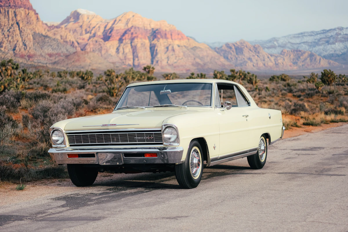 Vintage car parked on a desert road